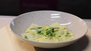 Tahta tepside ıspanak ve tereyağlı ravioli.