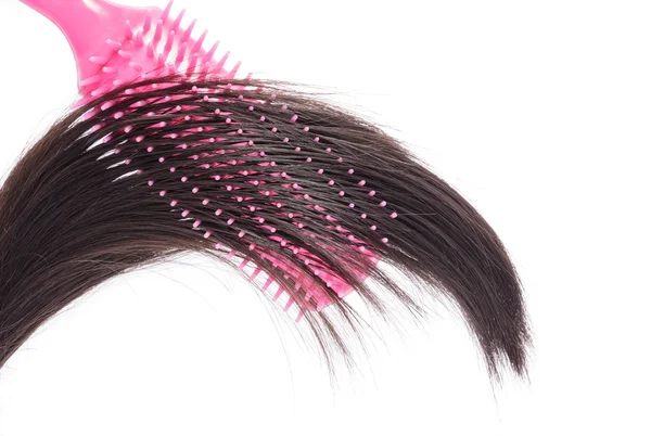 Rózsaszín hajkefe, fehér alapon fekete haj. — Stock Fotó