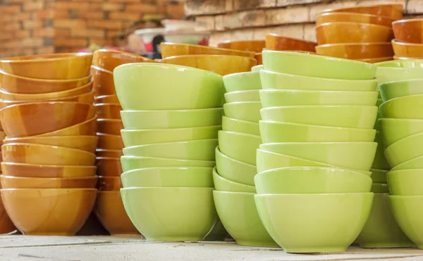 Stack of green and brown bowl in warehouse. — Stock Photo, Image