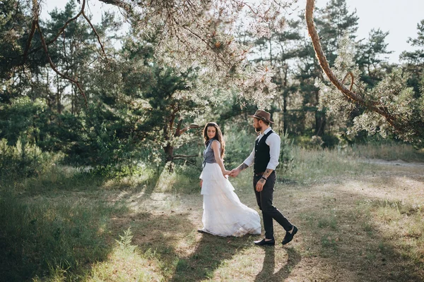 Woman in wedding dress and man in forest — Stock Photo, Image