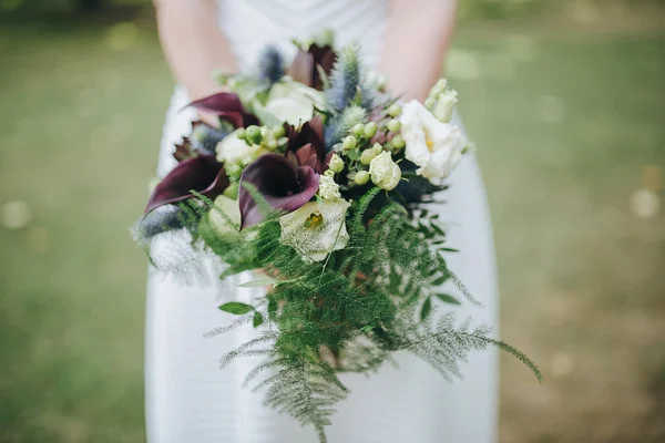 Mariée en robe blanche tenant bouquet — Photo