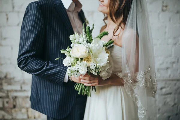 Bride and groom holding bouquet Stock Photo
