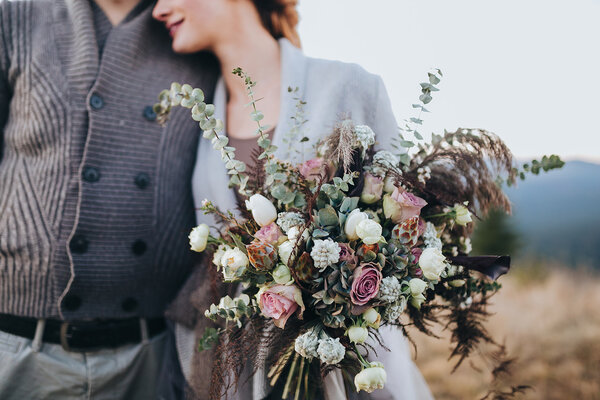 Bride and groom holding bouquet