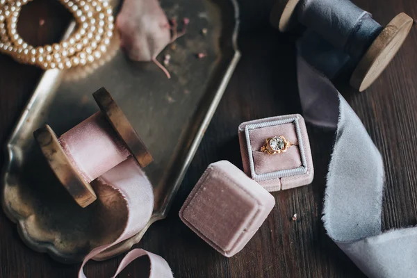 Silk ribbons and ring in box on table — Stock Photo, Image