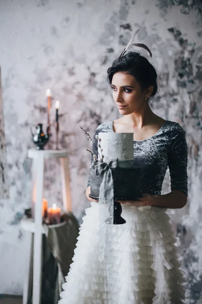 Bride holding wedding cake