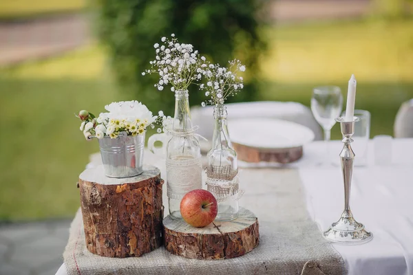 Wild flowers in glass bottles — Stock Photo, Image