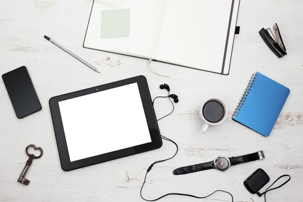 Workplace. Empty notepad, tablet pc and smart phone on white woo