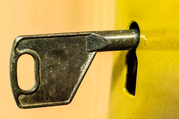 Old key is sitting in the door eye. — Stock Photo, Image
