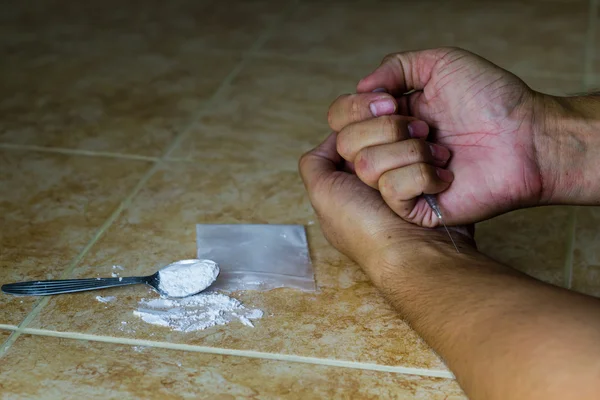 Human hand and a syringe — Stock Photo, Image