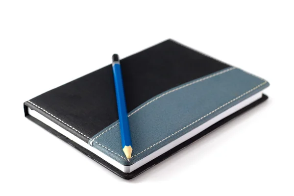 Modrou tužkou na černé kožené mech notebook — Stock fotografie