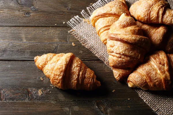 Croissants on rustic kitchen table — Stock Photo, Image