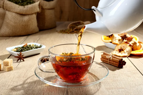 Tea pouring into glass cup — Stock Photo, Image