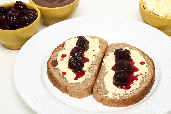 Cherry jam on bread — Stock Photo, Image