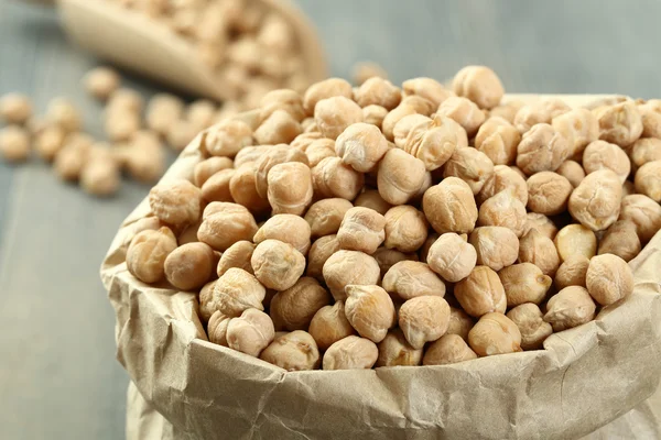 Chickpeas gray in spoon and paper bag — Stock Photo, Image