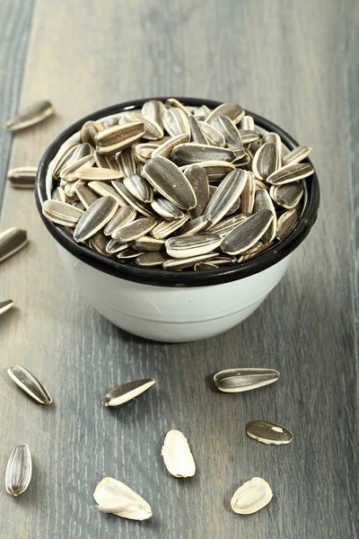 Sunflower seeds in metal bow — Stock Photo, Image