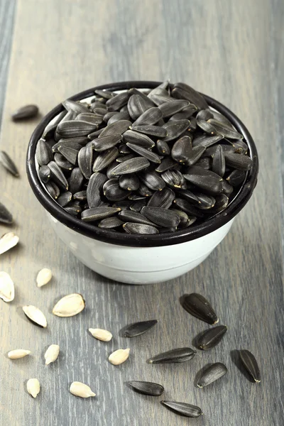 Sunflower seeds in metal bow — Stock Photo, Image