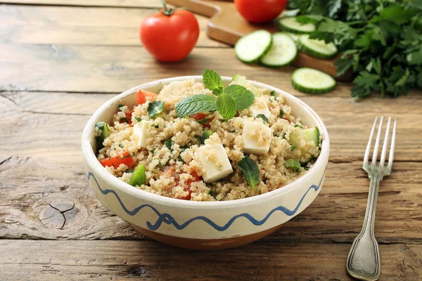 Quinoa salad with feta cheese in ceramic bowl — Stock Photo, Image