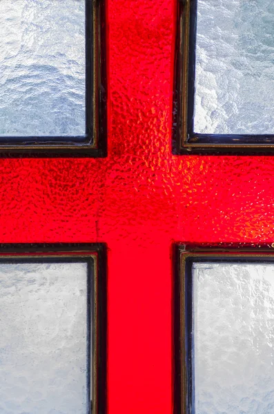 Cruz roja en una ventana de cristal — Foto de Stock
