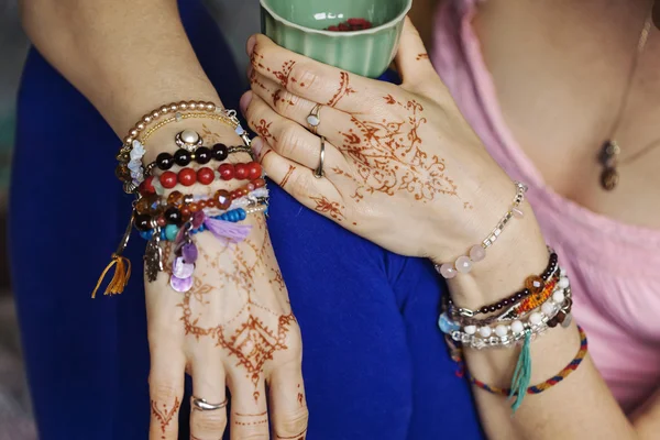 Manos femeninas con mehndi y muchas pulseras — Foto de Stock