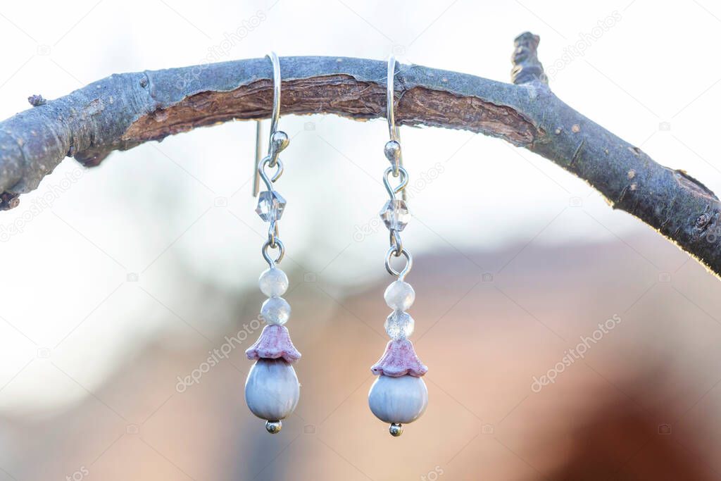 Faceted mineral stone beads romantic style earring hanging on natural background