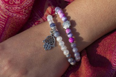 Mineral taşından bilezikler takan bir kadın. 