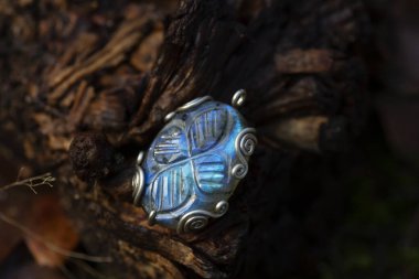 Blue labradorite pendant on natural background clipart