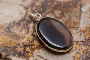 Kayalık zeminde gümüş metal mineral taş kolye