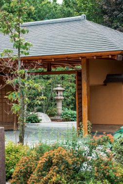 Japon bahçesinin girişinden taştan bir fenere bakıyorum.