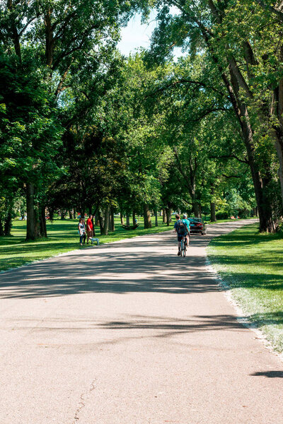 Bicyclist riding down a park path in Grand Rapids Michigan