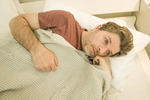 うつ病を患っている男 悲しいと落ち込んでいる男の家で劇的な肖像40代前半ベッドの上に横たわって不安問題を感じて絶望的で壊れた心 — ストック写真