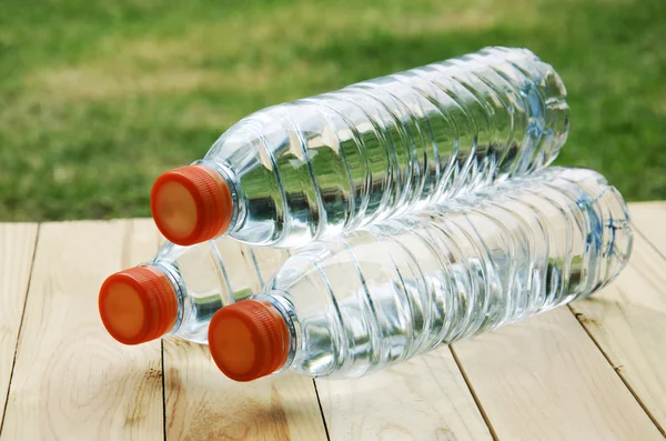 Бутылки с водой на деревянном полу — стоковое фото