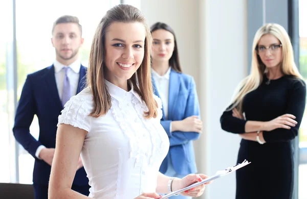Beautiful woman on the background of business people — Stock Photo, Image