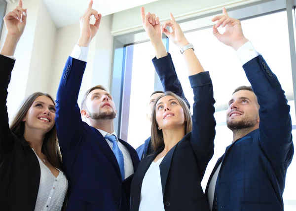 Group of five business people in a row pointing and looking up — Stock Photo, Image