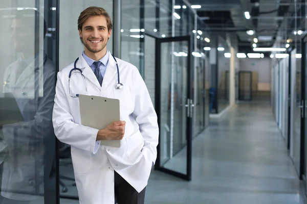 Knappe Vriendelijke Jonge Dokter Ziekenhuisgang Kijkend Naar Camera Glimlachend — Stockfoto