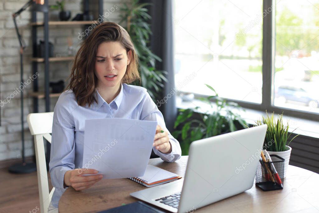 Happy entrepreneur woman sit at desk reading good news in post paper correspondence