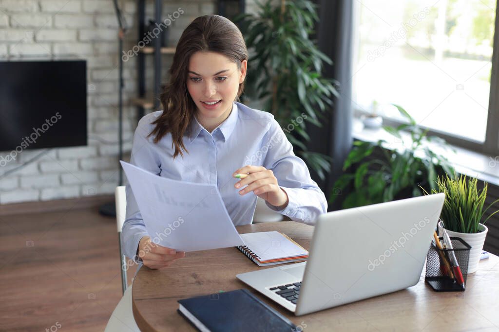 Happy entrepreneur woman sit at desk reading good news in post paper correspondence