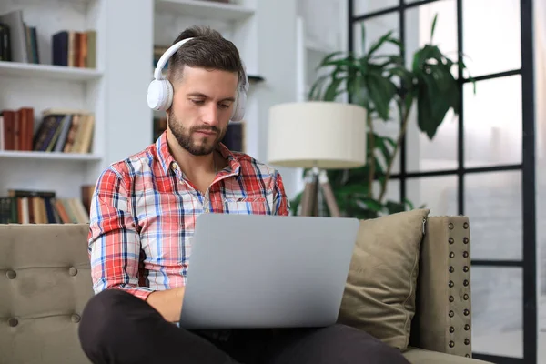 Concentrated Young Freelancer Businessman Sitting Sofa Laptop Working Remotely Online — Stock Photo, Image