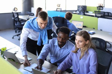 Takım genç profesyonelleri ofiste gelişigüzel tartışıyorlar. Yöneticiler tatilde dostça tartışıyorlar