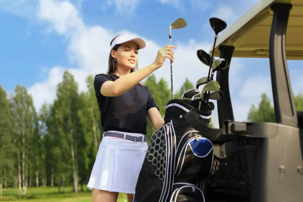 Professional Woman Golf Player Choosing Golf Club Bag Stock Photo