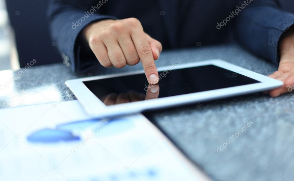 Woman hand touching screen on modern digital tablet pc.