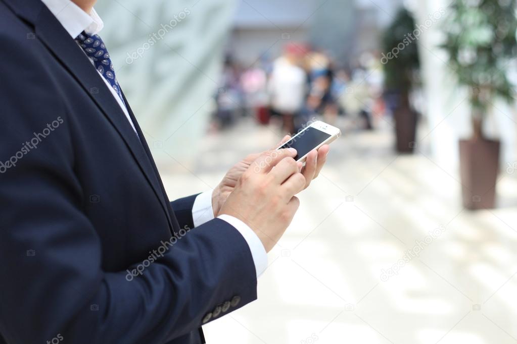 Close up of a business man using mobile