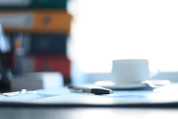 Office supplies and coffee cup on table — Stock Photo, Image