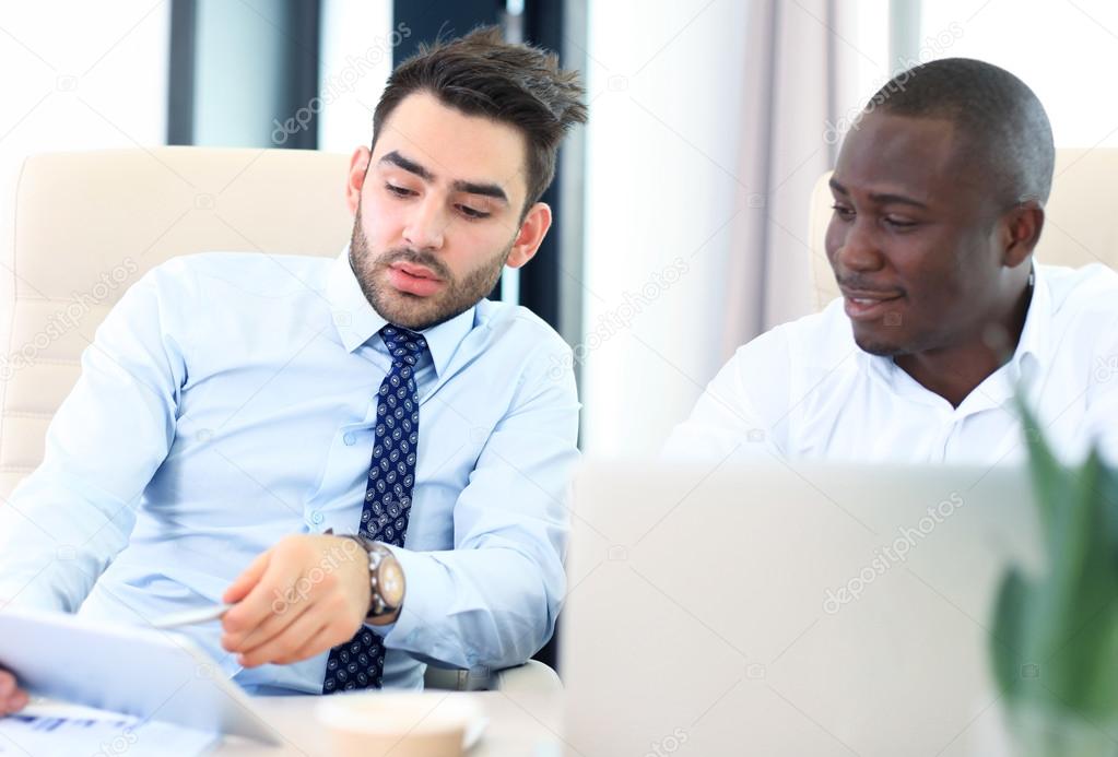Image of two young businessmen interacting