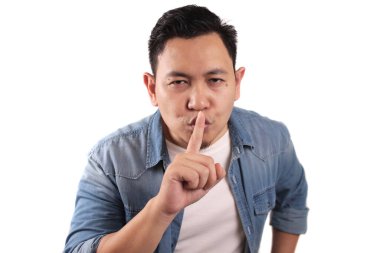 Sessiz olmak isteyen Asyalı bir gencin portresi, sessiz jest, sessizlik konsepti.