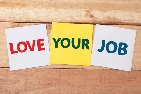 Love your job, text words typography written on color paper against wooden background, life and business motivational inspirational concept
