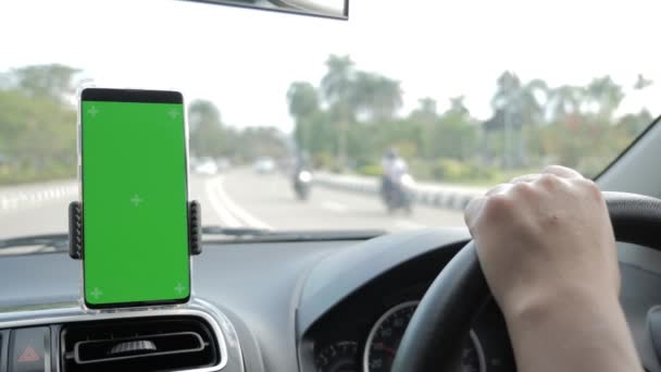 Close up image of smart phone on car mock up, riding a car with smartphone map navigation, blank phone green screen template — Stock Video