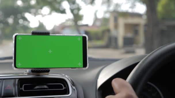 Close up image of smart phone on car mock up, riding a car with smartphone map navigation, blank phone green screen template — Stock Video