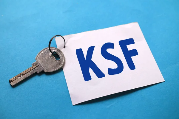 KSF key success factor, text words typography written on paper against blue background, life and business motivational inspirational concept