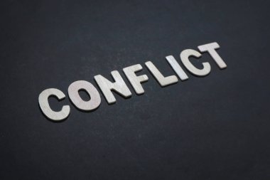 Conflict, text words typography written with wooden letter on black background, life and business motivational inspirational concept