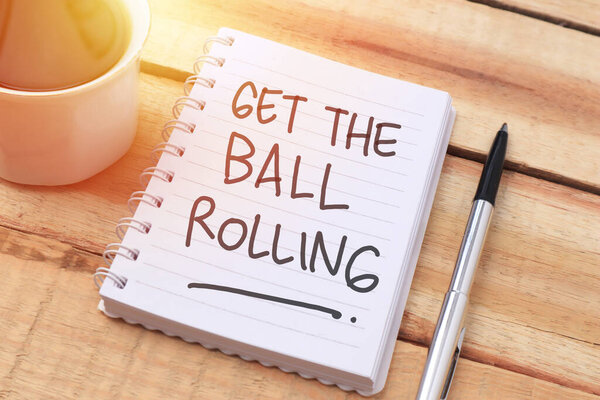 Get the ball rolling, text words typography written with paper, life and business motivational inspirational concept